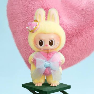 Toy figure with bunny ears and a bow tie on a pink heart background