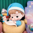 HACIPUPU-Whispers-of-My-World Small figurine of a character with a blue hat and white scarf, held in a hand.