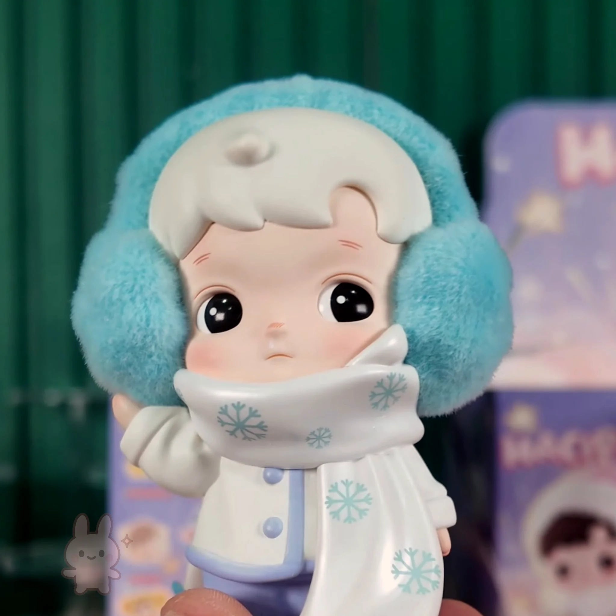 HACIPUPU-Whispers-of-My-World Toy figure of a character in winter clothing with a blue hat and white coat.