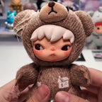 Hirono Road Journal Series Plush Doll Stuffed toy bear with a house on its paw held by a hand