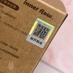 Hirono The Other One Brown cardboard box with a QR code scratch-off label and 'inner flow' branding.
