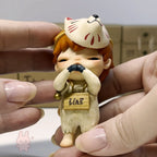 Hirono The Other One Hand holding a figurine with a cat-like head and 'Liar' tag