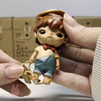 Hirono The Other One Hand holding a small figurine of a character with brown hair and a bow tie, against a neutral background.