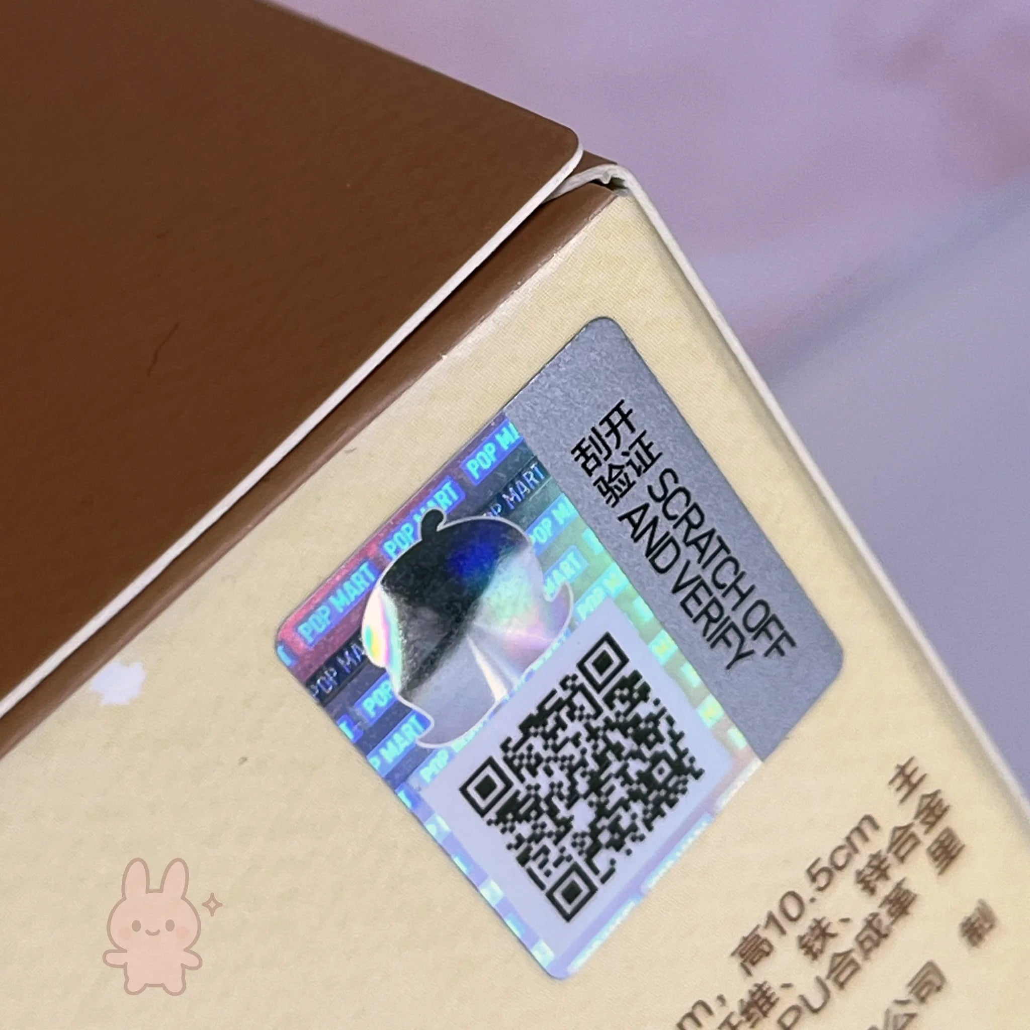 Molly Winter Fit Check Mini Bag Holographic scratch-off label with QR code on a product packaging