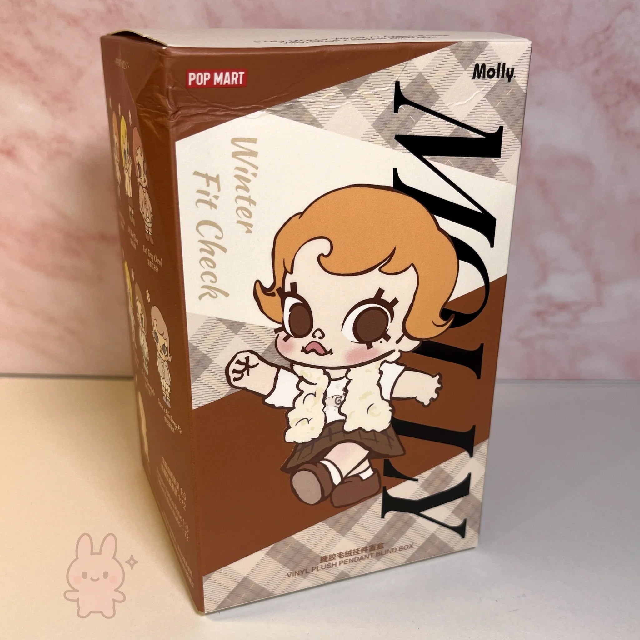 Baby Molly - Winter Fit Check Product packaging with a cartoon character on a checkered background