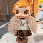 Baby Molly - Winter Fit Check Toy figure with orange hair and a fluffy coat, wearing a sweater with a cat design.
