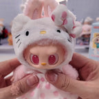 Labubu THE MONSTERS Sanrio Plush toy resembling a character with large eyes and a bow, held in hands.