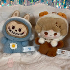 POPBEAN fluffy and cozy Two plush toys with animal-themed costumes on a fluffy white surface with a glittery background.