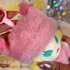 POPBEAN fluffy and cozy Plush toy with pink fuzzy top held by a hand against a colorful background