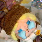 POPBEAN fluffy and cozy Plush keychain with a cartoon character wearing a brown hat and yellow outfit.