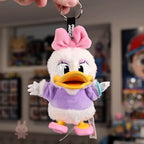 Plush keychain of a cartoon character with a pink bow in a store setting