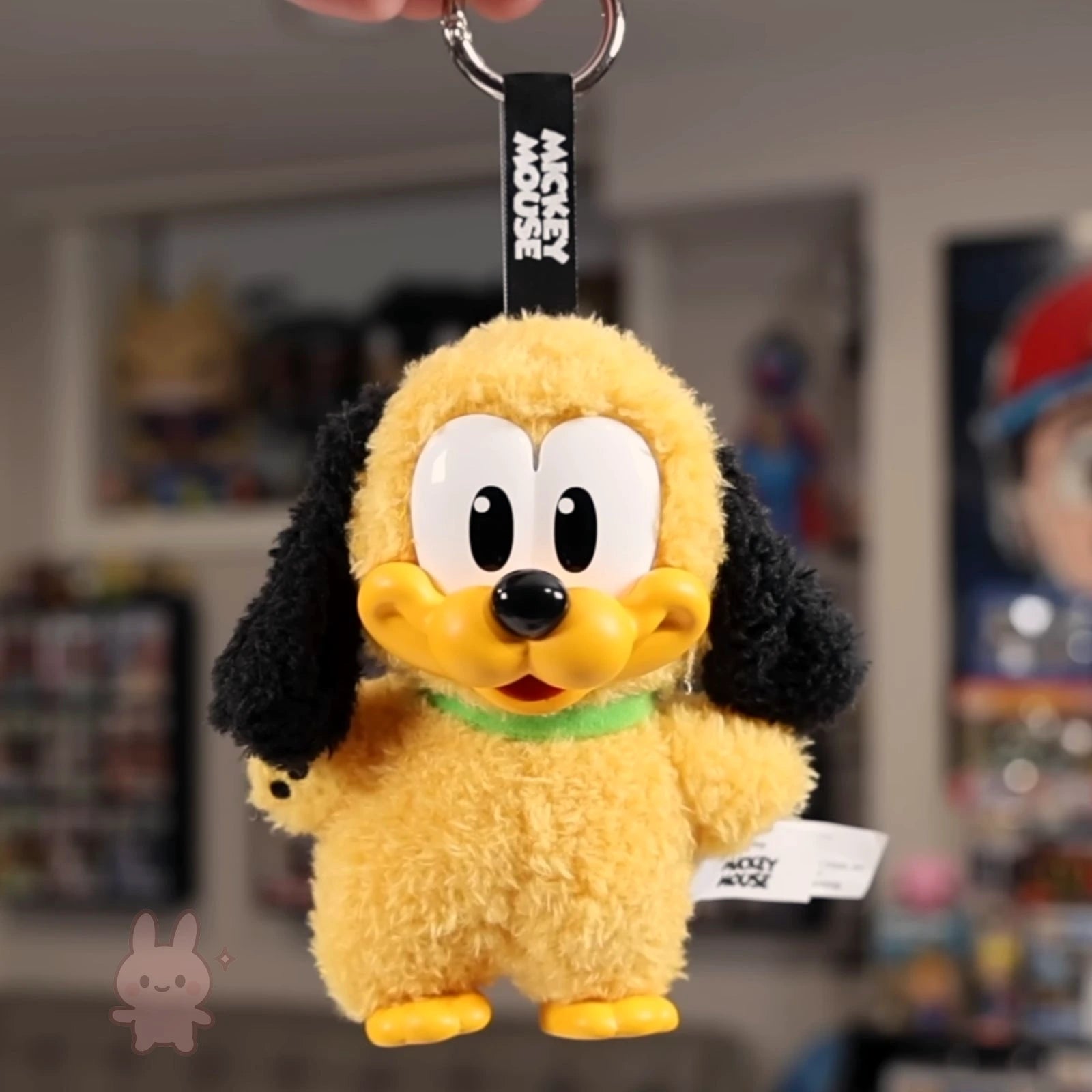 Plush keychain of a cartoon character with a blurred background