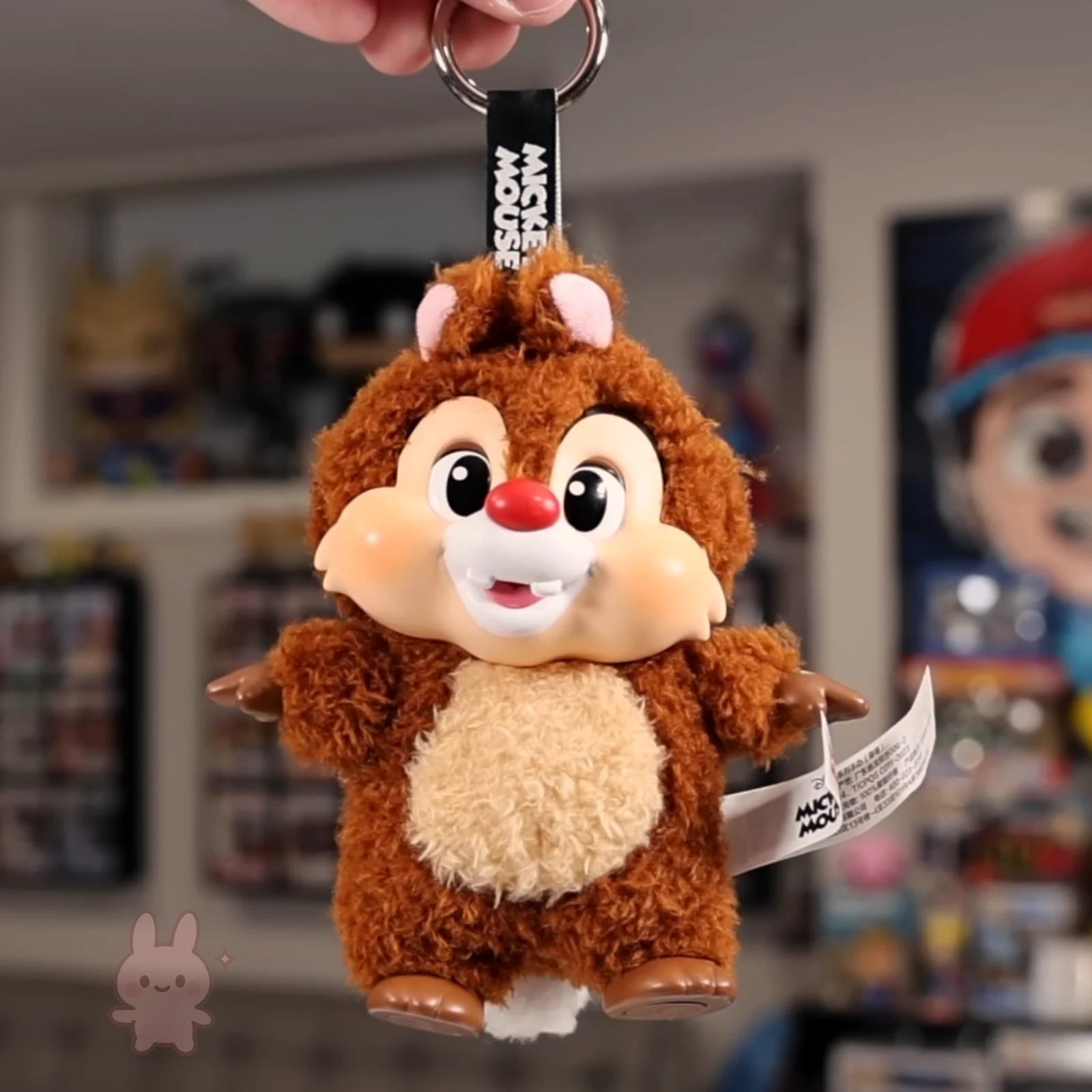 Plush keychain of a cartoon character with a blurred background