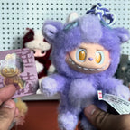 Pop-Mart-Have-a-good-run Purple plush toy with a card featuring a similar design, held against a blurred background.