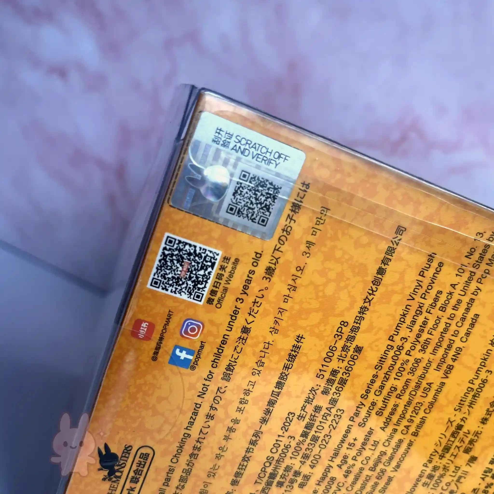 Pop Mart Labubu Halloween Product packaging with QR codes and text on a textured surface