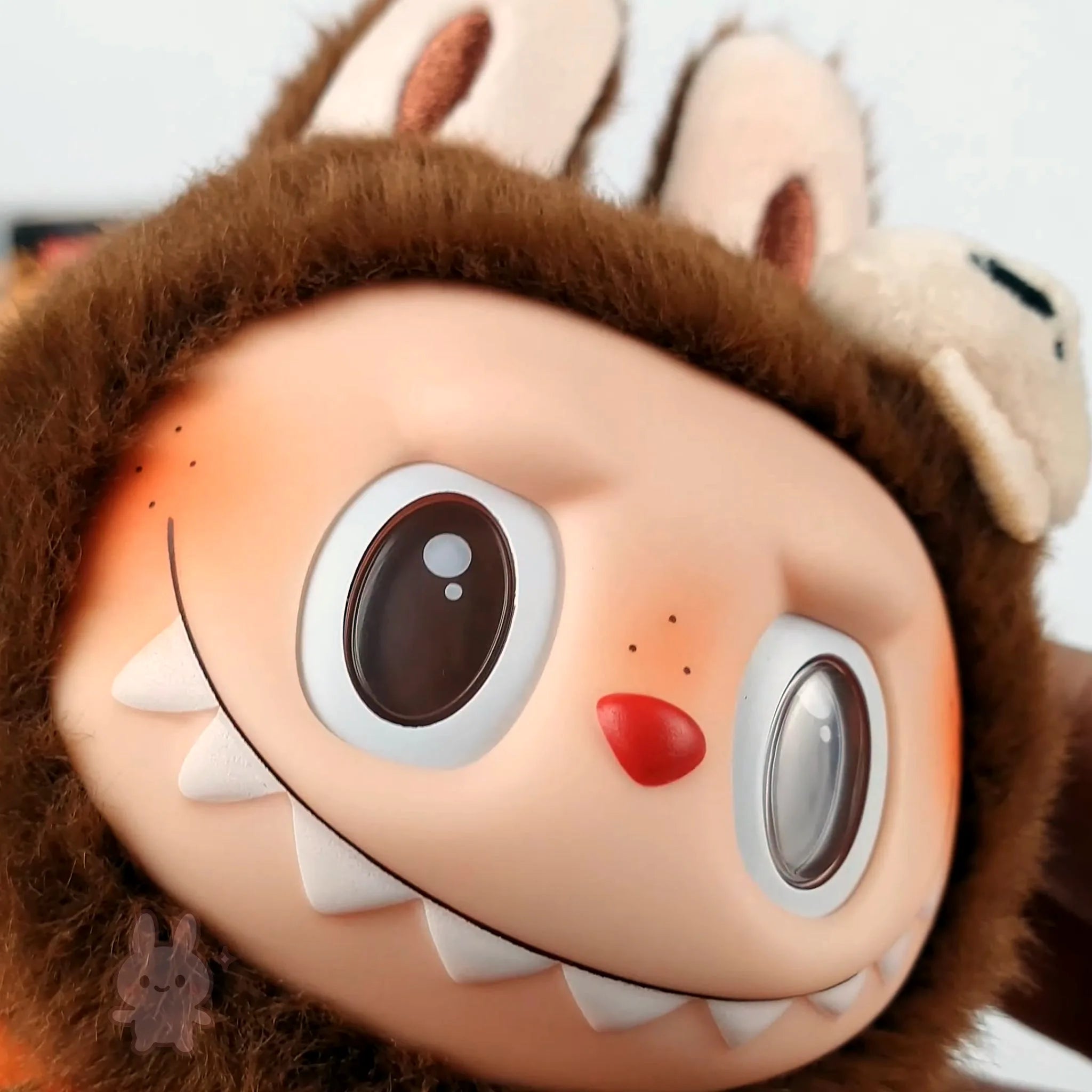 Pop Mart Labubu Halloween Close-up of a plush toy with a cartoonish face and brown fur.