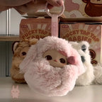 Pop Mart PUCKY Tap Tap Babies Plush toy with pink fluffy hood held by a hand, with 'Pucky Tap Tap' boxes in the background.