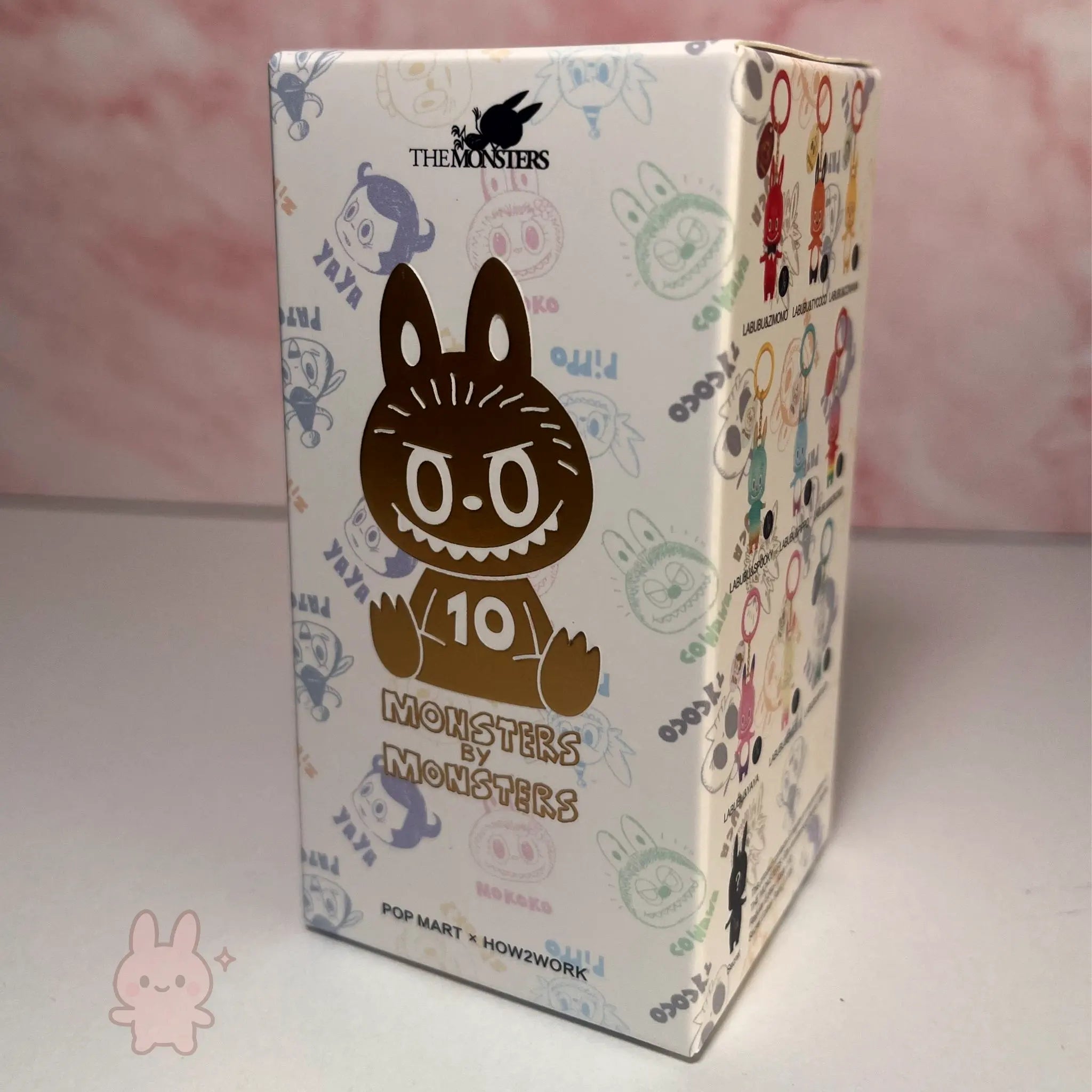 Pop Mart The Monsters 10th-anniversary Box with cartoon character design and text on a pink background