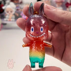 Pop Mart The Monsters 10th-anniversary Colorful toy figure held in a hand with a blurred background