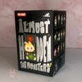 Pop Mart The Monsters Almost Hidden  Box of 'Almost Hidden The Monsters' toy collection by Pop Mart on a light pink background.