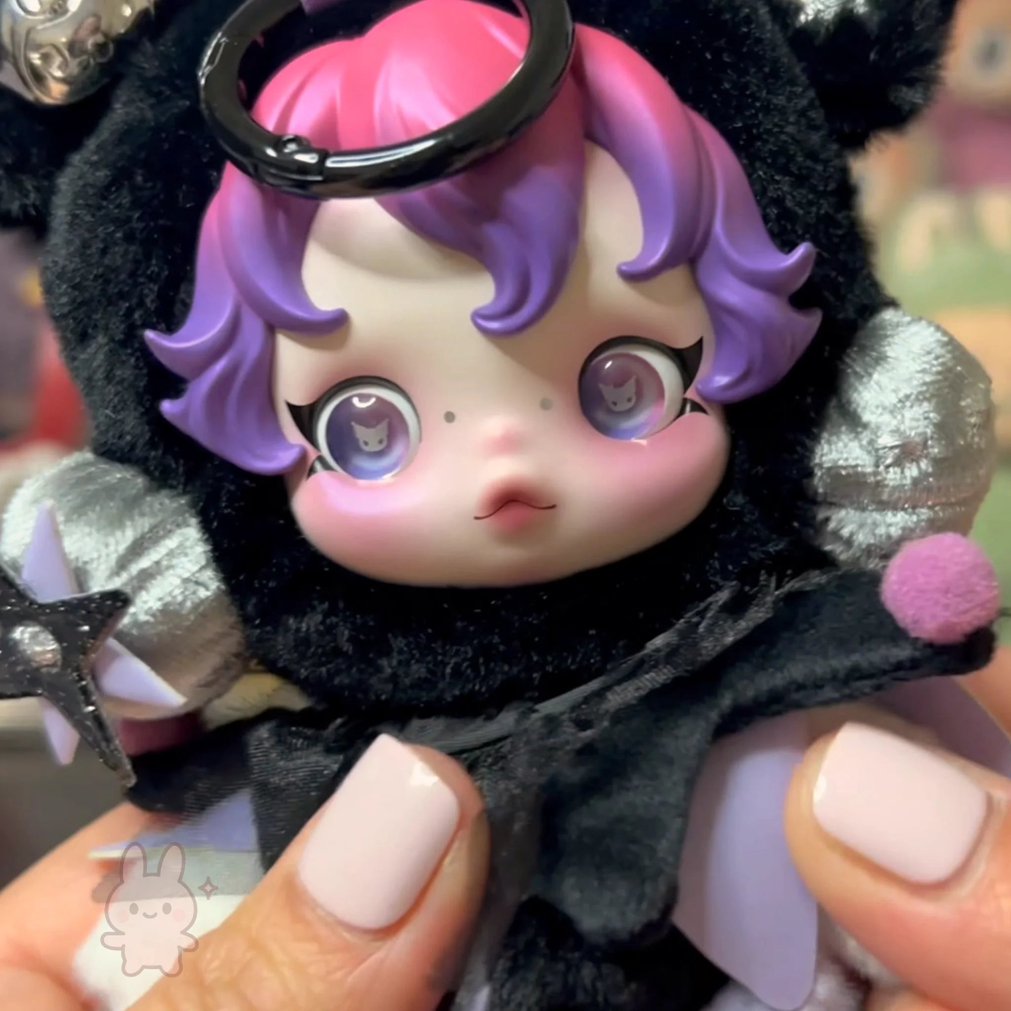 SKULLPANDA KUROMI Plush Plush toy with purple hair and large eyes held by a person with light pink nail polish.