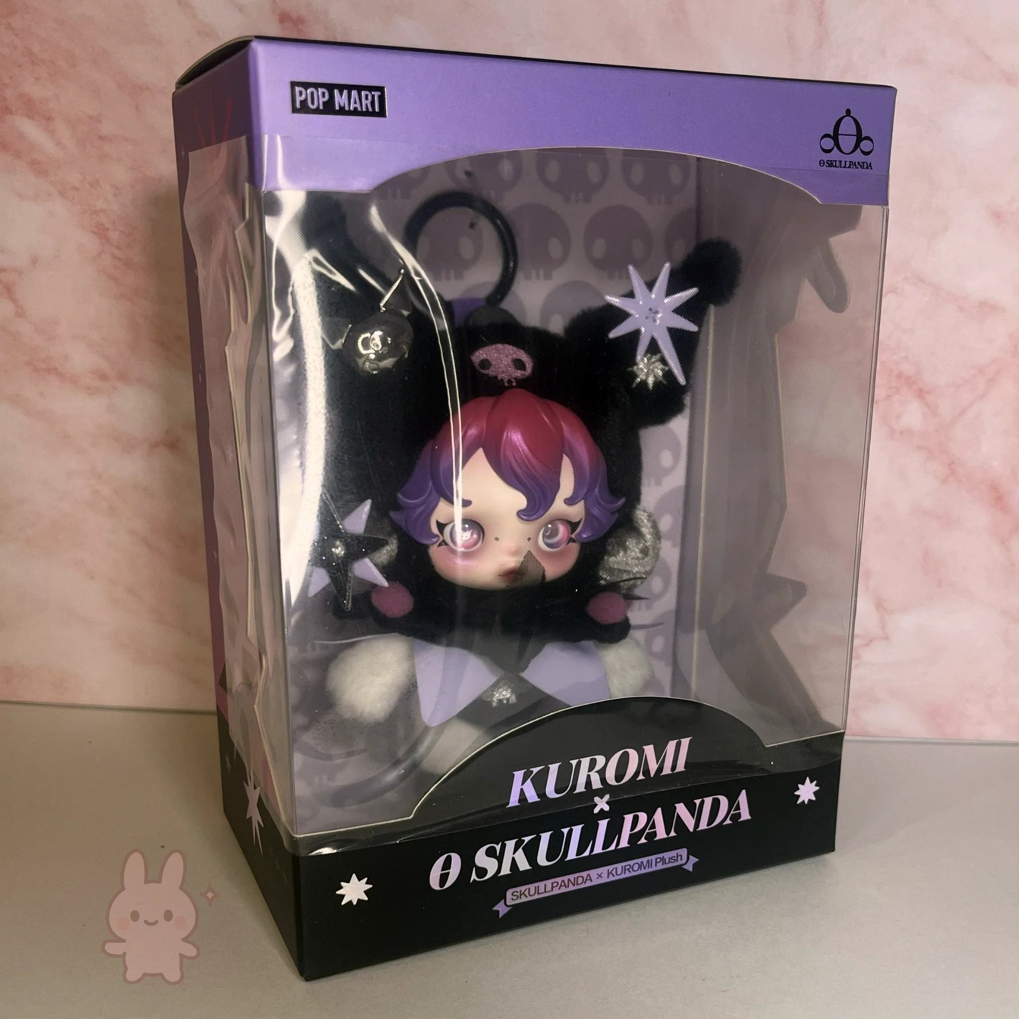 SKULLPANDA KUROMI Plush toy in packaging with 'Pop Mart' branding on a pink marble background