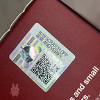 Skullpanda-the-feast-begins Scratch-off security label with QR code on a red surface