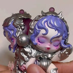 Skullpanda-the-feast-begins Detailed figurine with purple hair and silver decorative elements held by a hand.