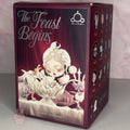 Skullpanda-the-feast-begins product packaging with 'The Feast Begins' text and illustrations on a maroon background.