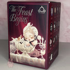 Skullpanda-the-feast-begins product packaging with 'The Feast Begins' text and illustrations on a maroon background.