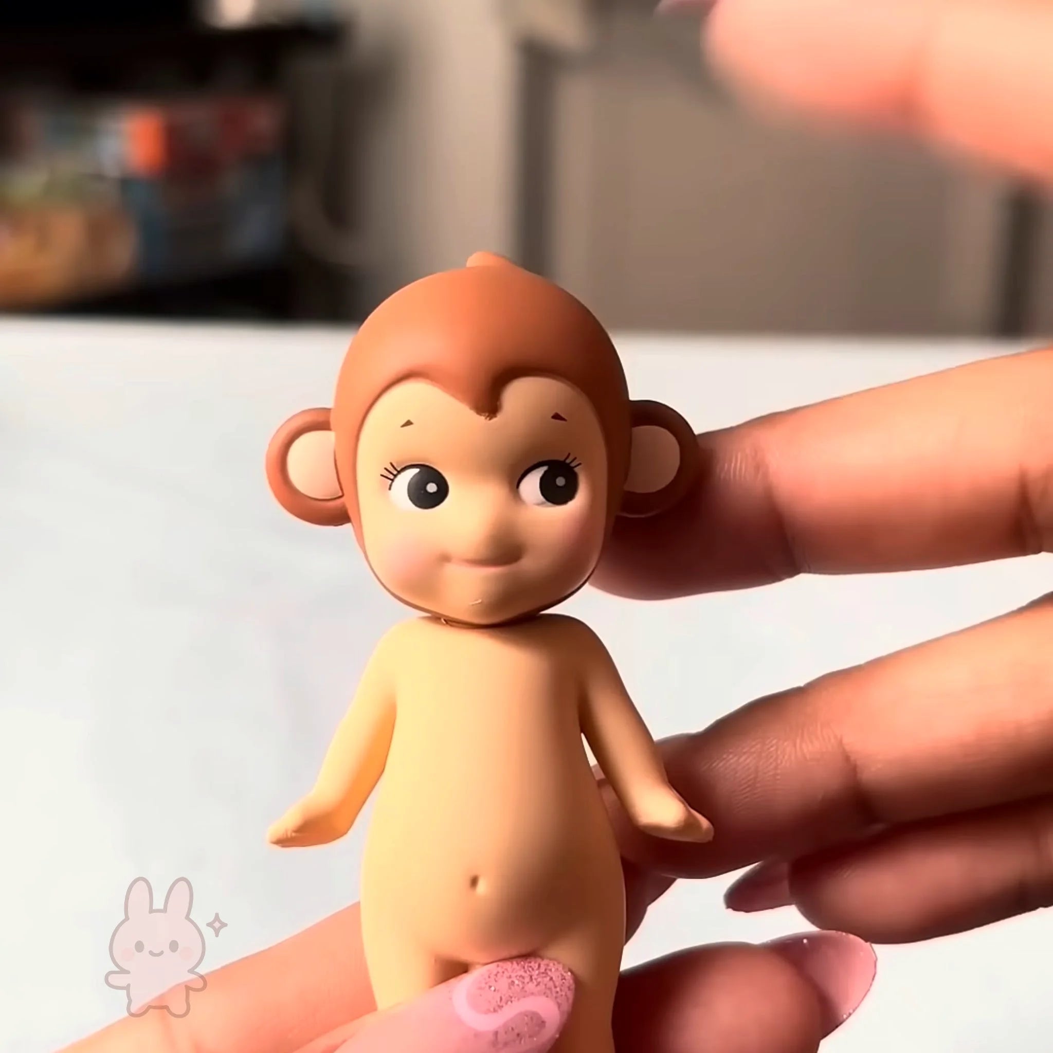 Sonny Angel Animal Series Ver.1 Hand holding a small monkey figurine with a blurred background