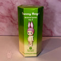 Green packaging of Sonny Angel Animal Series Ver.1 figure with a pink bunny hat on a pink marble background.
