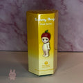 Sonny Angel fruit Yellow packaging box for a Sonny Angel fruit series figure on a marbled background