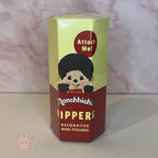 Box of Monchhic hiippers decorative mini figures with cartoon character on a pink and white background