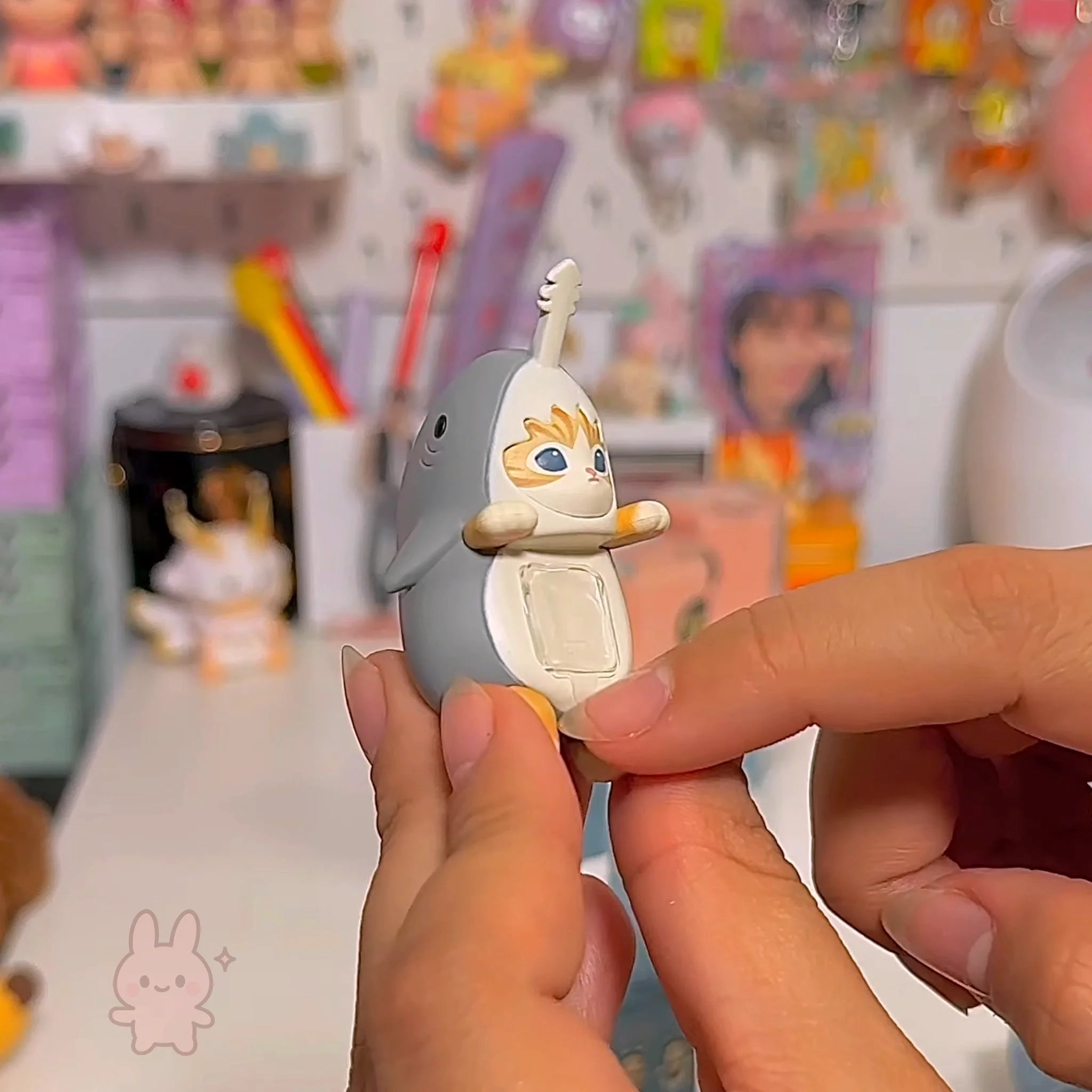 Sonny Angel Mofusand Hippers Person holding a small figurine with a colorful background