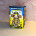 Space molly 100 series4 Box of a 'Mega Space Molly' toy with a colorful design on a pink marble background.