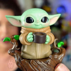 Star Wars Grogu Tiny But Mighty Toy figure of a character holding a cup with a blurred background