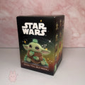 Star Wars Grogu Tiny But Mighty Box of a 'Star Wars' toy figure with a character on a pink marble background