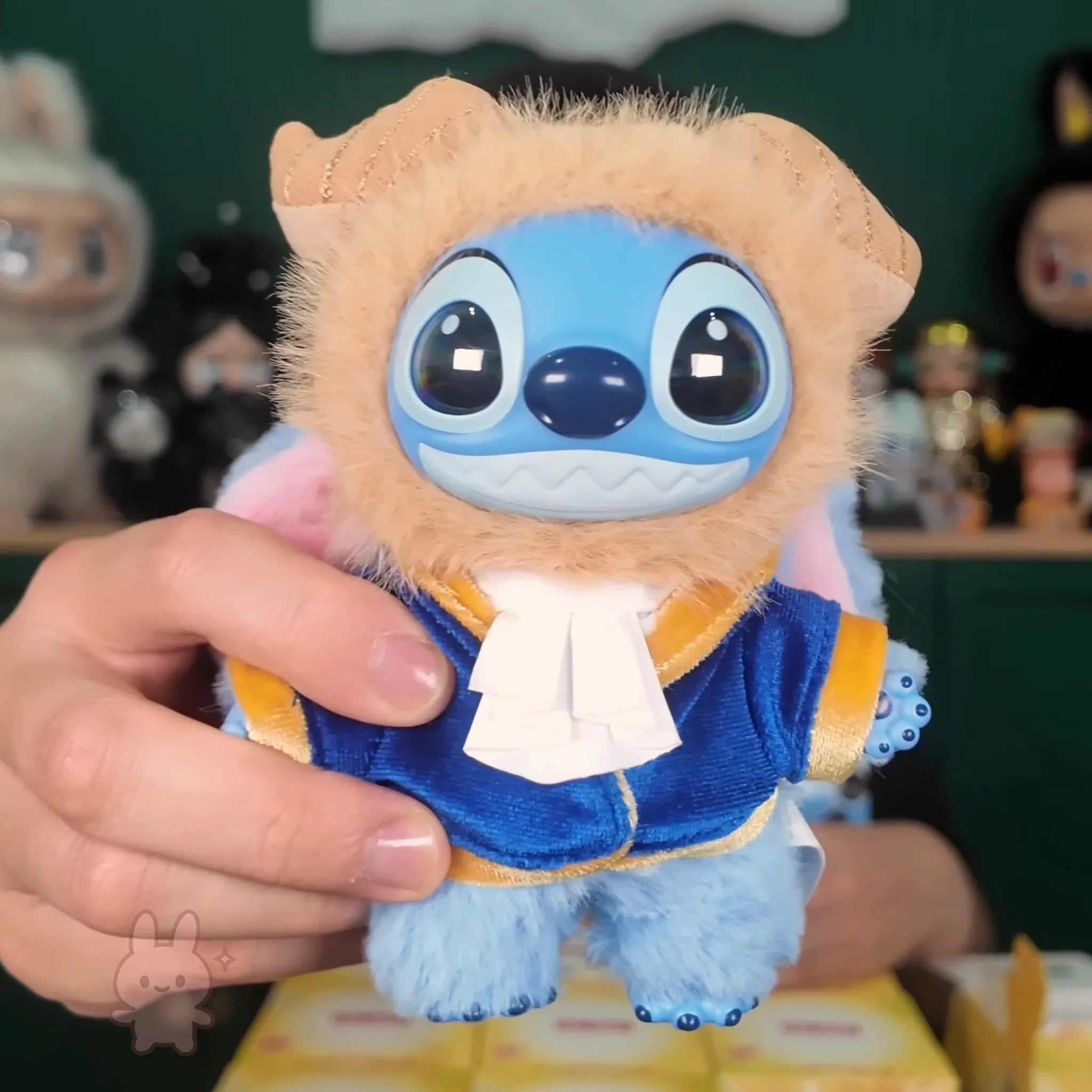 Stitch Adventure toy resembling a character with blue face and beige body held by a hand.