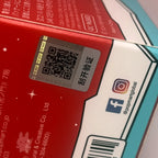 The Monsters Coca-Cola Close-up of a product packaging with QR code and social media icons.