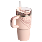 Pink tumbler with floral pattern and handle on a white background
