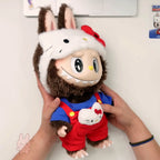 The monsters hello kitty large plush toy resembling a character in a Santa outfit held by hands against a light background