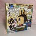Colorful collectible trading card box with cartoon characters on a pink background