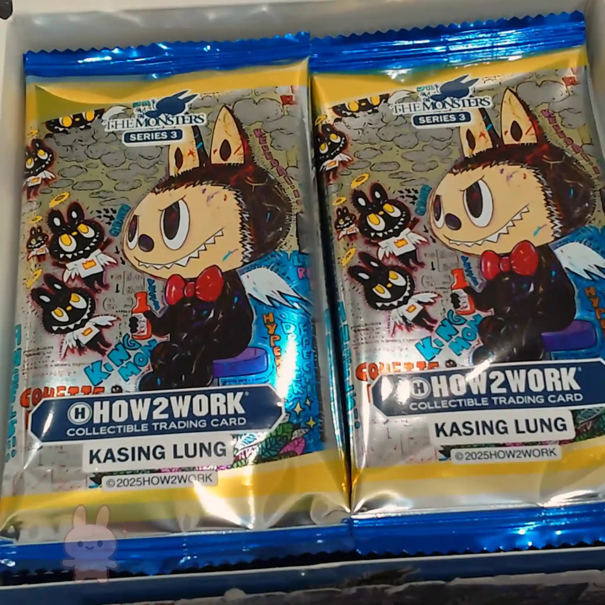 Two collectible trading card packages featuring cartoon characters with blue and yellow borders.