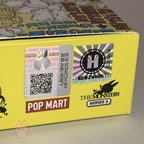 Yellow box with Pop Mart branding and a QR code on a gray background