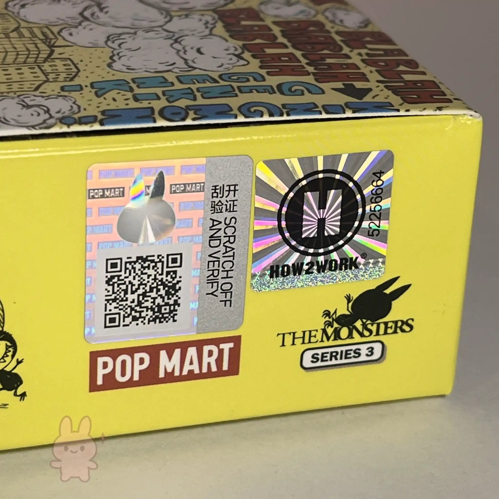 Yellow box with Pop Mart branding and a QR code on a gray background