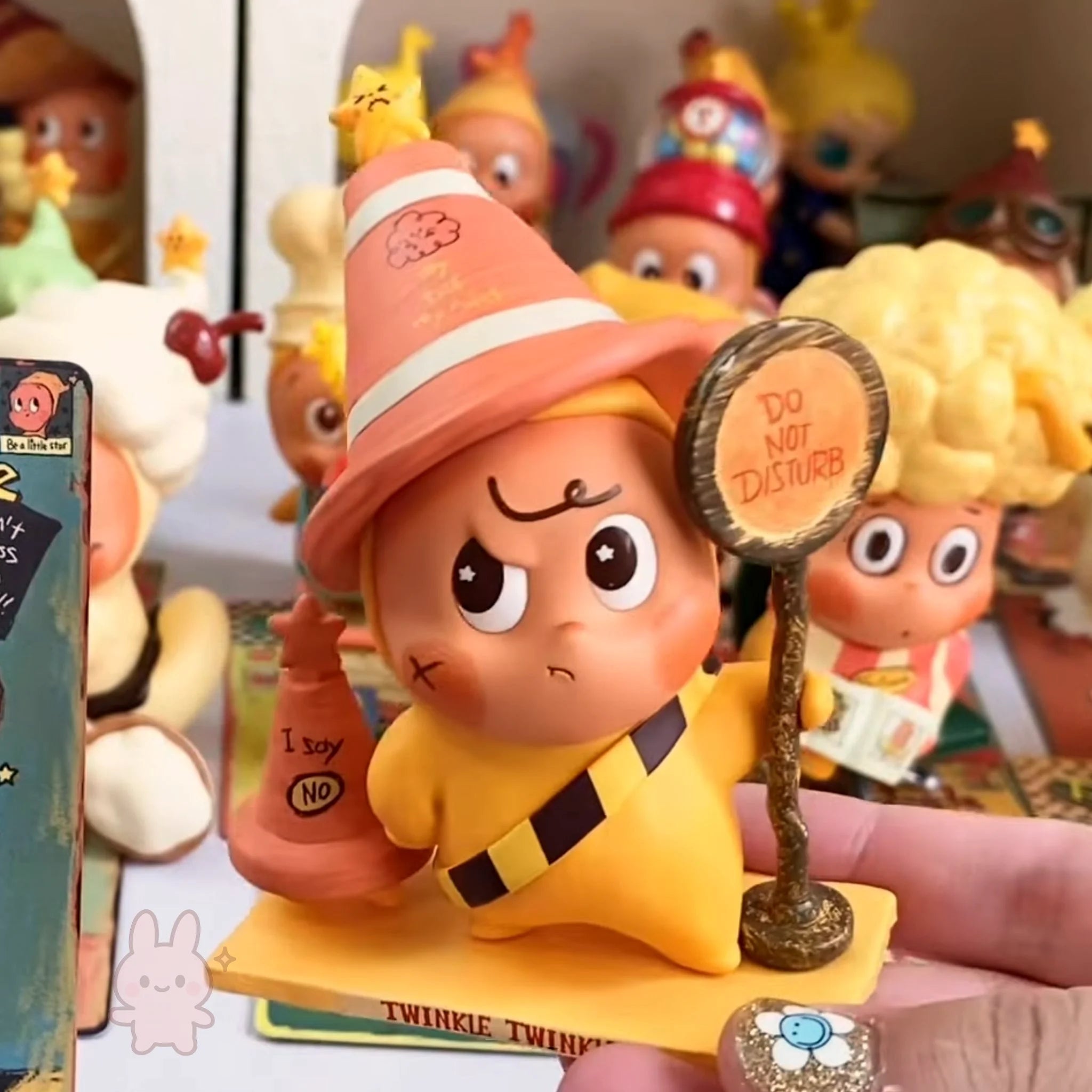 Twinkle Twinkle Be a Little Star Toy figure with a sign saying 'Do Not Disturb' surrounded by other toys.