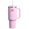 Pink Stanley tumbler with a handle on a white background