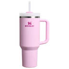 Pink Stanley tumbler with a handle on a white background
