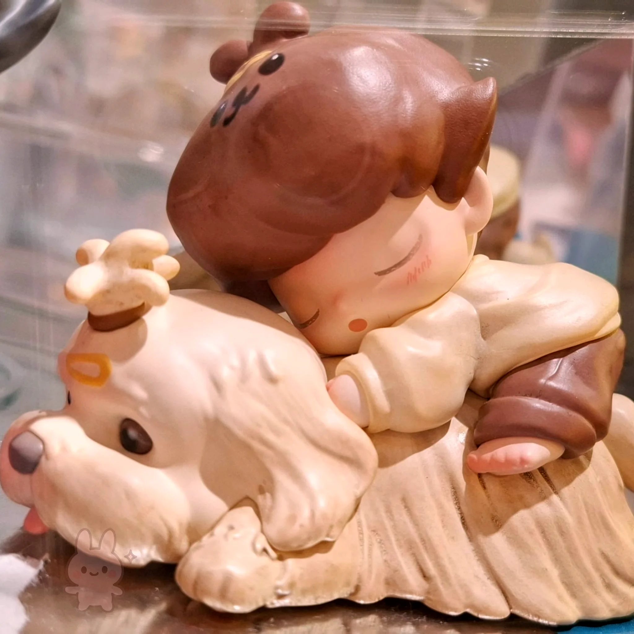 dimoo-the-missing-day Cute figurine of a child with a dog on a reflective surface
